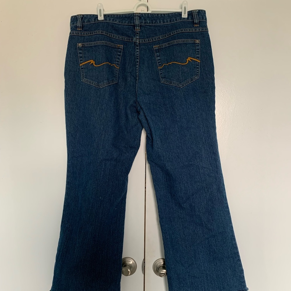 Nicole Miller brand slightly faded jeans with frayed hem